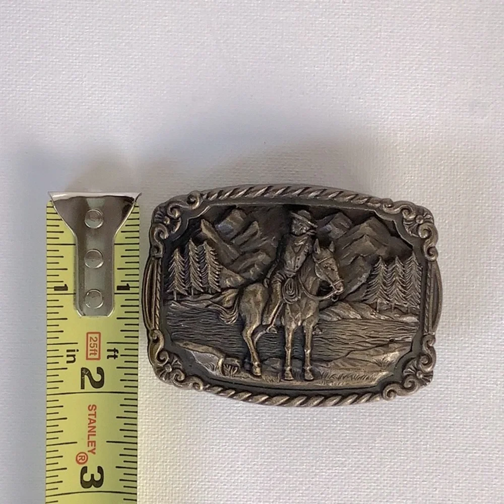 Vintage 1970’s belt buckle with cowboy on a horse with trees & mountains